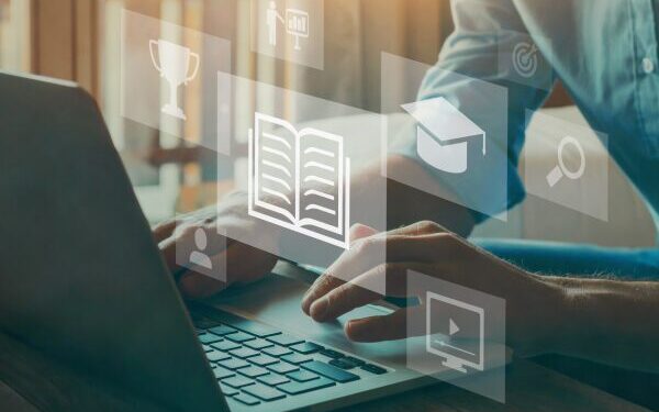 typing on laptop with icons in the air