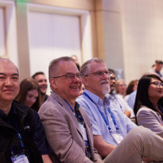 male conference attendees at a session