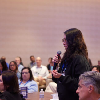 session speaker walking among the audience