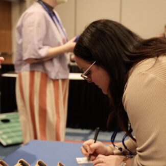 attendee signing a piece of paper
