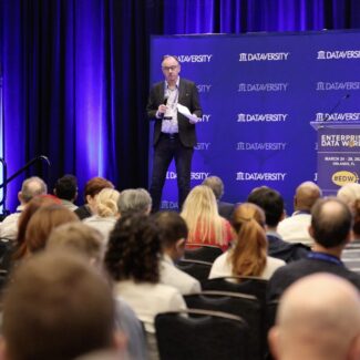 speaker standing on stage presenting
